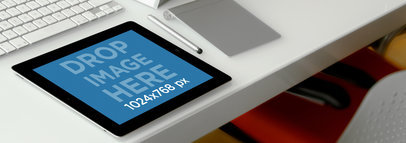 Mockup of an iPad at the Edge of a Clear Desk