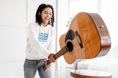 Pullover Hoodie Mockup Featuring a Happy Woman Smashing a Guitar 