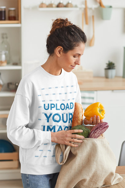 Sweatshirt Mockup of a Woman Unpacking Her Groceries at Home
