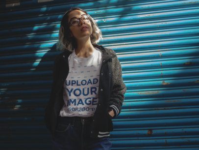 Young Edgy Woman Wearing a Tshirt While Lying Against a Blue Metal Shutter Template a13563