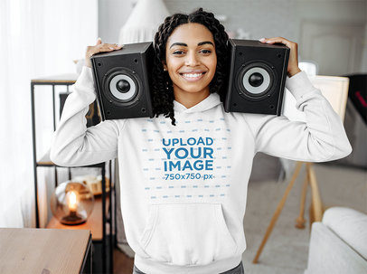 Hoodie Mockup of a DJ Holding Two Loud Speakers