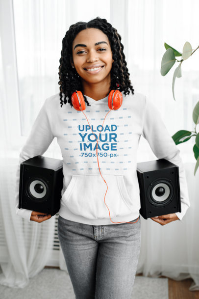 Pullover Hoodie Mockup Featuring a Woman Carrying Two Speakers