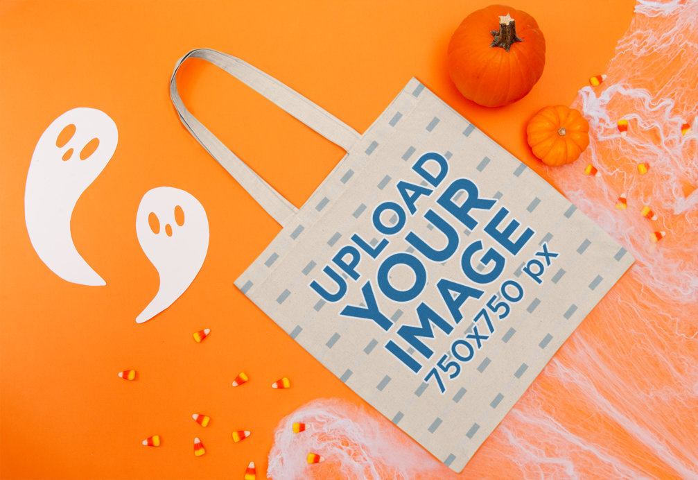 Mockup of a Flat Laid Tote Bag Featuring a Halloween Setting