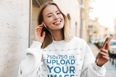 Mockup of a Happy Woman with a Sweatshirt Putting Headphones On