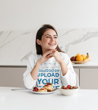 Sweatshirt Mockup Featuring a Happy Woman Eating Breakfast