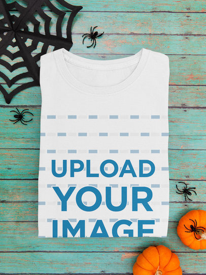 Mockup of a Folded T-Shirt Featuring Halloween Decorations
