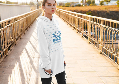 Mockup of a Young Woman Wearing a Customizable Oversized Hoodie 