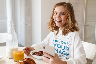 Sweatshirt Mockup Featuring a Girl Having Cereal for Breakfast