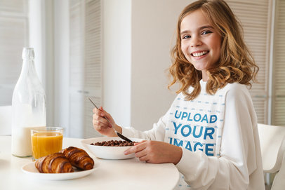 Sweatshirt Mockup of a Smiling Girl Eating Breakfast