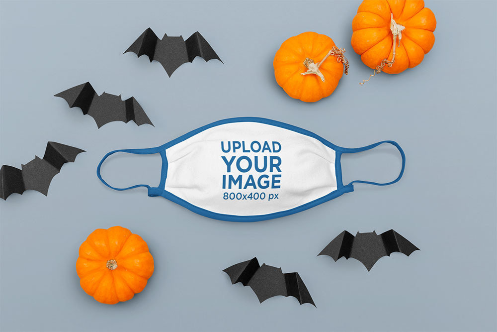 Mockup of a Face Mask Placed Among Some Halloween Decorations