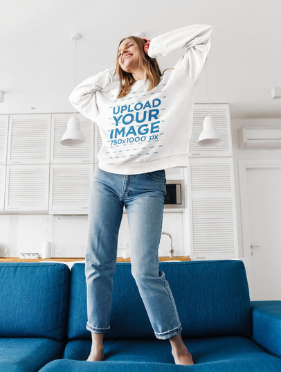 Sweatshirt Mockup of a Happy Woman Dancing on the Couch