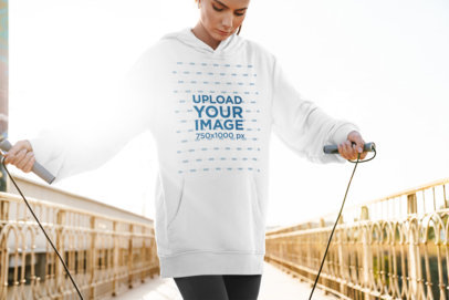 Mockup of a Woman Wearing an Oversized Hoodie While Exercising 