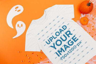 Mockup of a Flat Laid T-Shirt on a Surface with Halloween Items