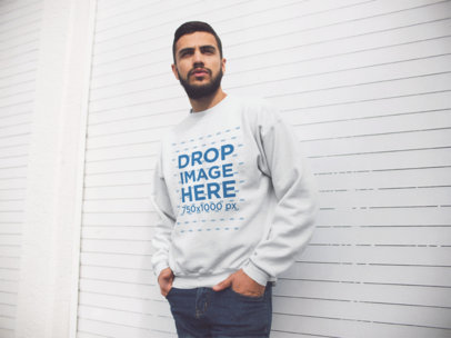 Young Hispanic Man Wearing a Crewneck Sweatshirt While Standing Near a White Facade Template a13427