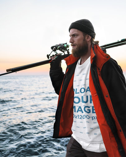 Mockup of a Fisherman Wearing a Sweatshirt with the Sea in the Background