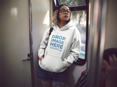 Mockup of a Young Hipster Girl Wearing a Pullover Hoodie While in the Subwaya13553