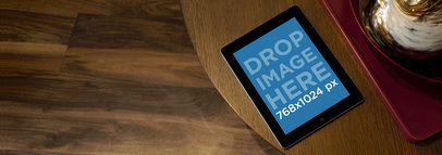 Wide Mockup of an iPad in Landscape Position over a Wooden Table