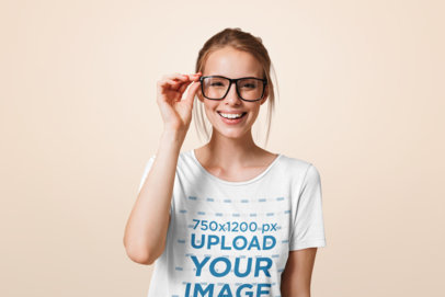 T-Shirt Mockup of a Happy Woman with Glasses in a Studio