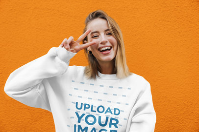 Crewneck Sweatshirt Mockup of a Happy Woman Doing a Peace Sign