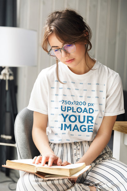 Round-Neck T-Shirt Mockup of a Woman Reading at Home