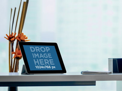 Mockup of an iPad in Landscape Position over a Business Shelf