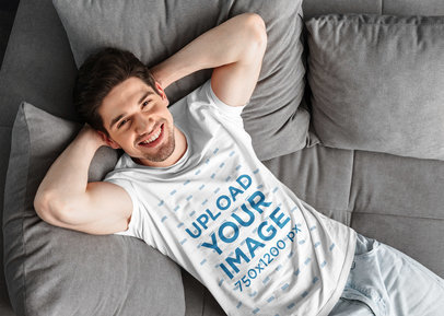 T-Shirt Mockup of a Man Chilling on a Sofa