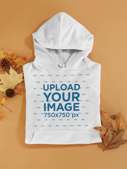 Mockup of a Folded Hoodie Among Some Autumn Leaves m126