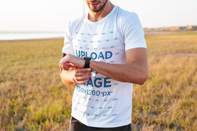 T-Shirt Mockup of a Runner Looking at the Time