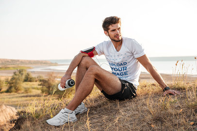 T-Shirt Mockup Featuring a Runner and a Beach in the Background