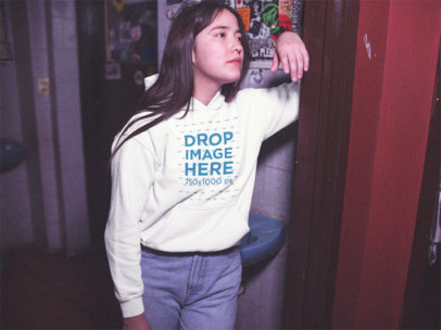 Young Girl Wearing a Pullover Hoodie While Waiting Outside a Bathroom a13593