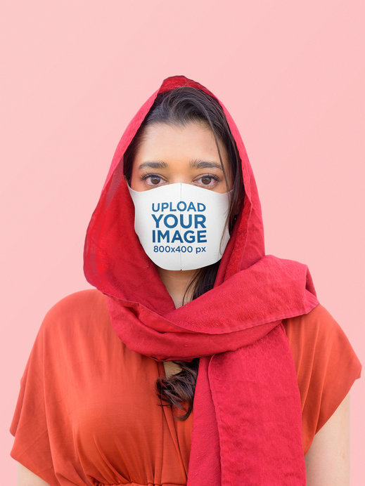 Mockup Featuring a Serious Woman Using a Sublimated Face Mask at a Studio