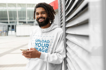 Pullover Hoodie Mockup of a Happy Man Leaning on a Wall 