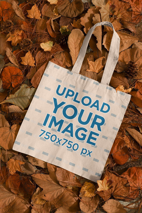 Mockup of a Sublimated Tote Bag Placed Over a Bunch of Autumn Leaves 