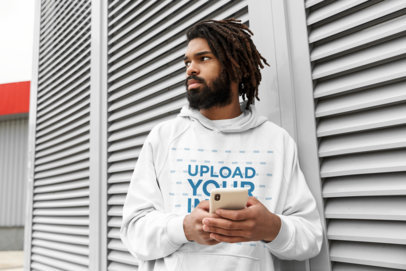 Hoodie Mockup Featuring a Man with Locs Using His Phone