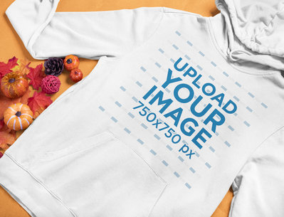Mockup of a Pullover Hoodie Placed by Some Small Pumpkins and Autumn Leaves 