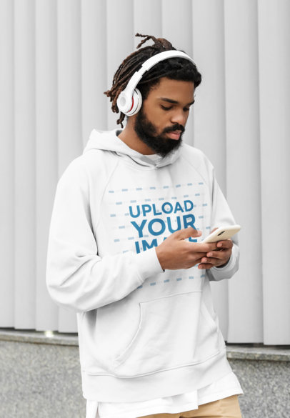 Mockup of a Serious Bearded Man Wearing a Pullover Hoodie on the Street