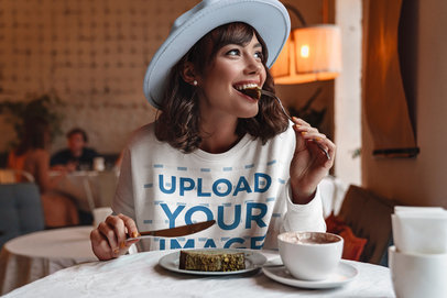 Sweatshirt Mockup of a Woman Eating a Cake at a Coffee Store