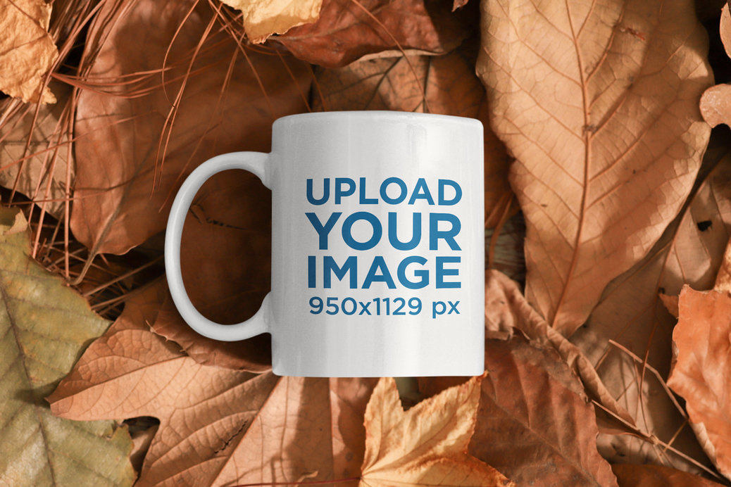 Mockup Featuring an 11 oz Coffee Mug Laid on a Bunch of Fall Leaves 