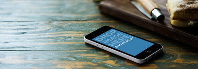 Wide Mockup Featuring an iPhone 5C Lying over a Wooden Surface