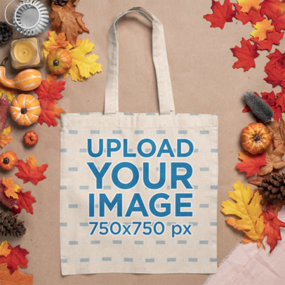 Mockup of a Tote Bag Lying Flat Among Autumn Decorations