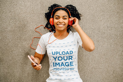 Mockup of a Woman with a T-Shirt Lying on the Floor and Listening to Music 