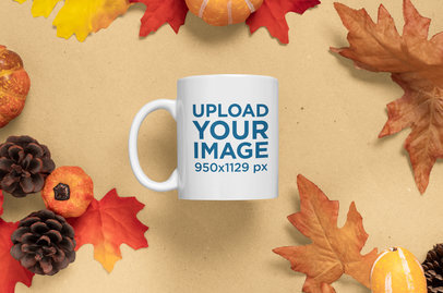 Mockup of an 11 oz Coffee Mug Surrounded by Fall Season Leaves