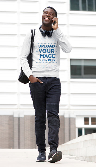 Mockup of a Man with a Heathered Sweatshirt Walking and Talking on the Phone