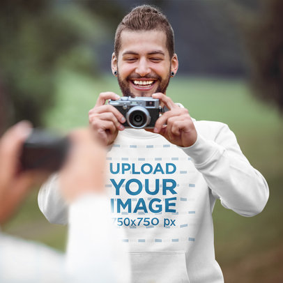 Pullover Hoodie Mockup of a Happy Man Taking a Picture 