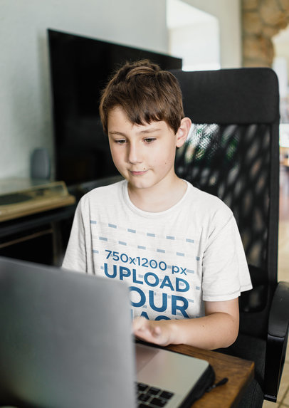 T-Shirt Mockup of a Kid Writing in a Computer 