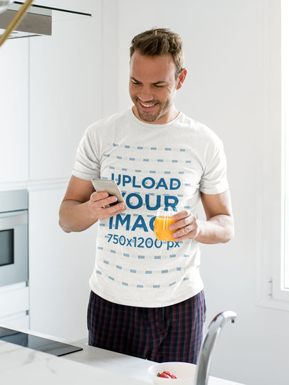T-Shirt Mockup of a Man Drinking Orange Juice at Home