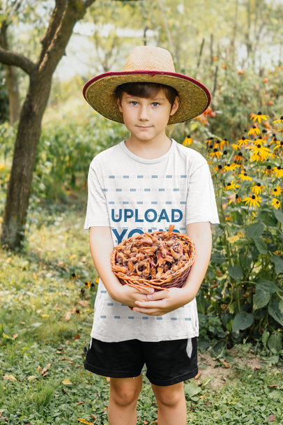 Mockup of a Kid with a T-Shirt Holding a Basket of Chestnuts