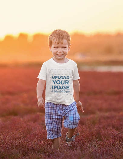 T-Shirt Mockup of a Little Boy Walking Through an Open Field