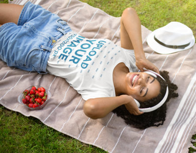 T-Shirt Mockup of a Woman Listening to Music on a Picnic 