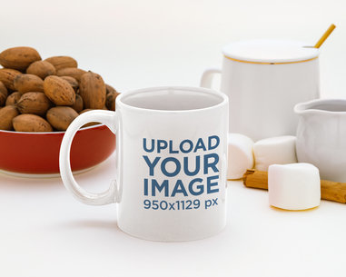 Mockup of an 11 oz Coffee Mug Surrounded by Marshmallows and Walnuts